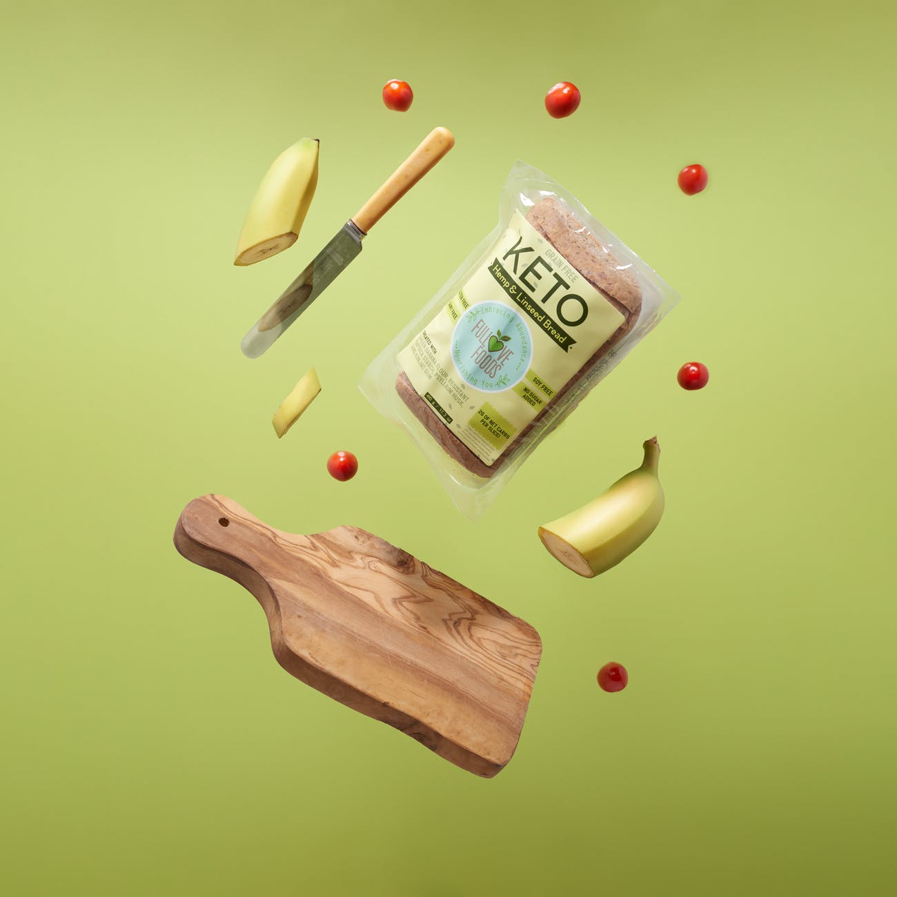 keto bread wooden chopping board with knife and fork sliced banana and cherry tomatoes keto diät essen