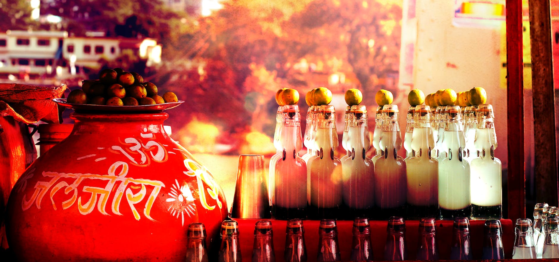 glass bottles beside red ceramic container